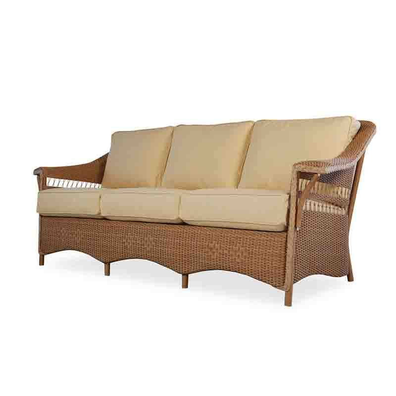 Wicker outdoor sofa with beige cushions on a white background