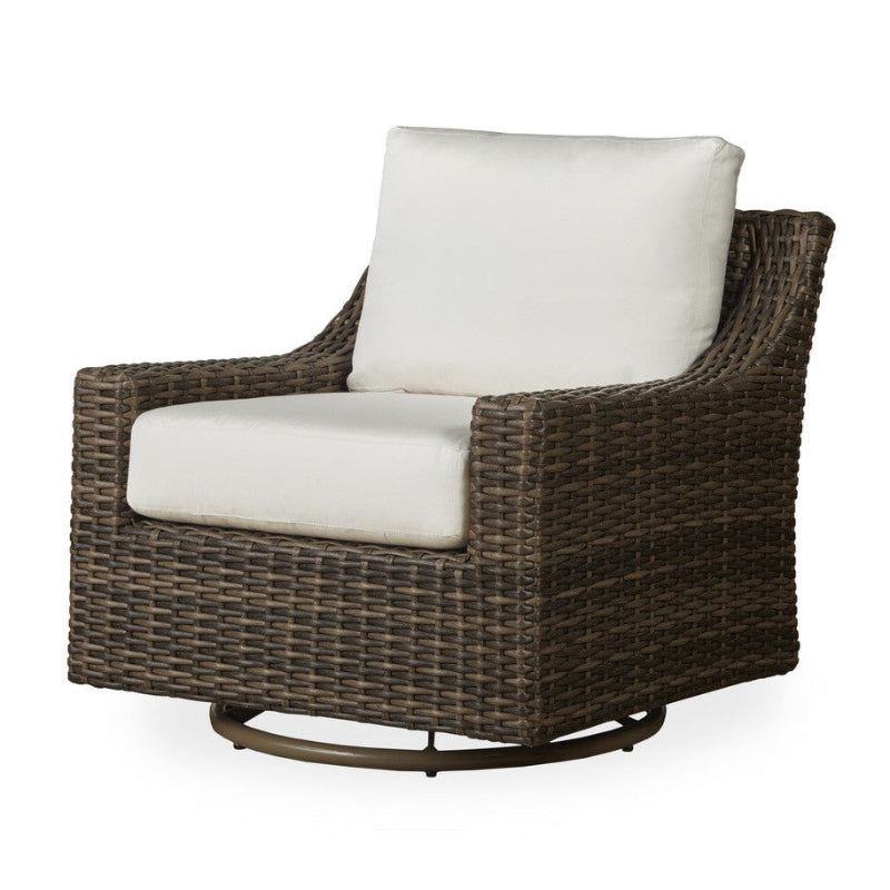 Wicker swivel chair with white cushions on a white background