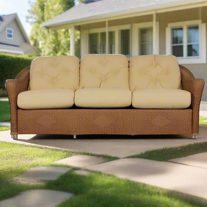 Beige sofa with wicker frame on a white background