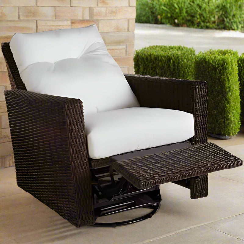 Brown wicker recliner chair with white cushions on a patio