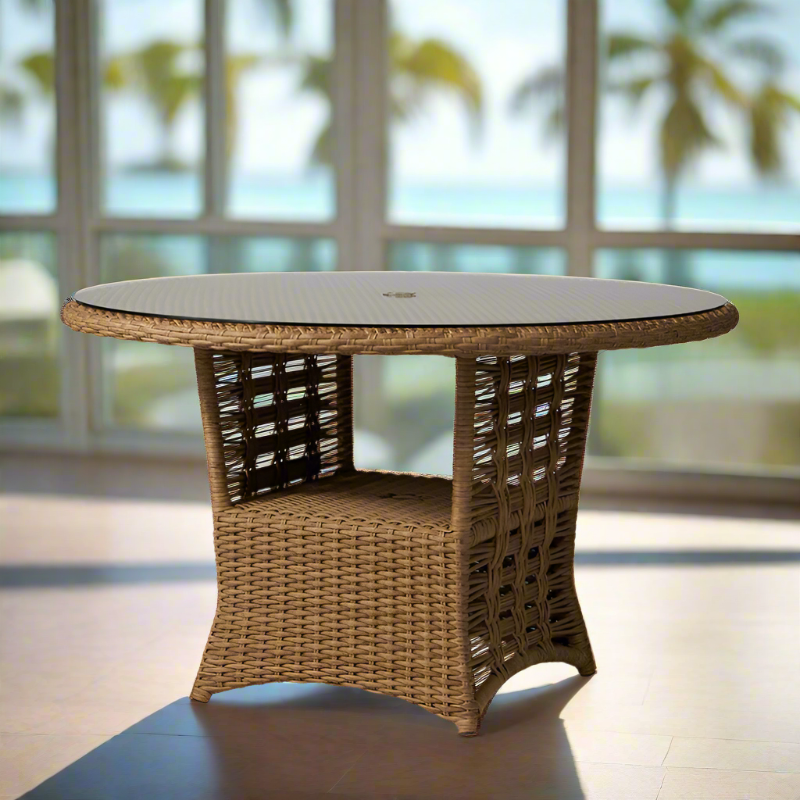 Round wicker table with a glass top in an outdoor setting