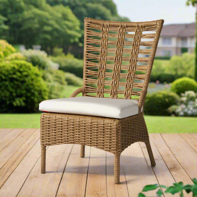 Wicker chair with a white cushion on a wooden deck in a garden setting