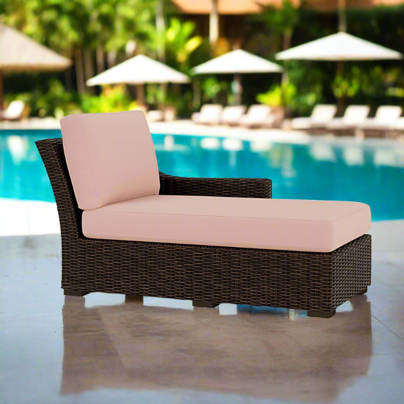 Outdoor lounge chair with pink cushions by a poolside