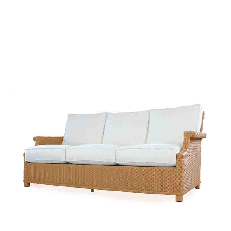Wicker outdoor sofa with white cushions on a white background