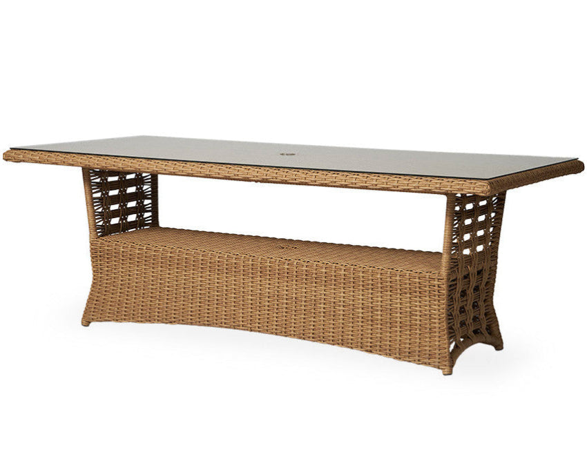 Wicker outdoor table with a glass top on a white background