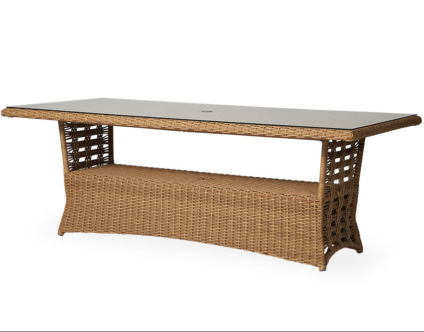 Wicker outdoor table with a glass top on a white background