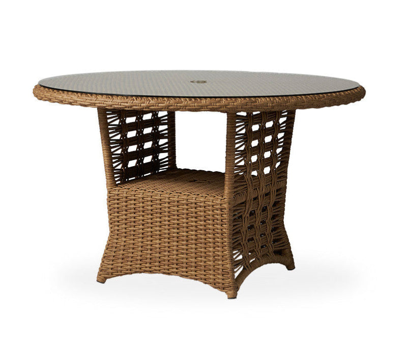 Round wicker table with a glass top on a white background