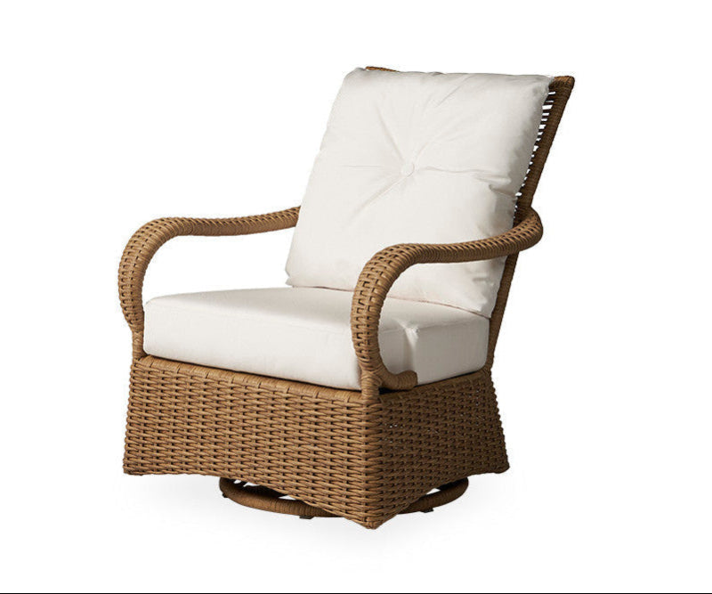 An outdoor patio chair with a wicker frame and a white cushion, part of the Lloyd Flanders Magnolia collection.