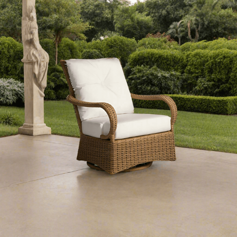 Brown wicker chair with white cushions on a patio