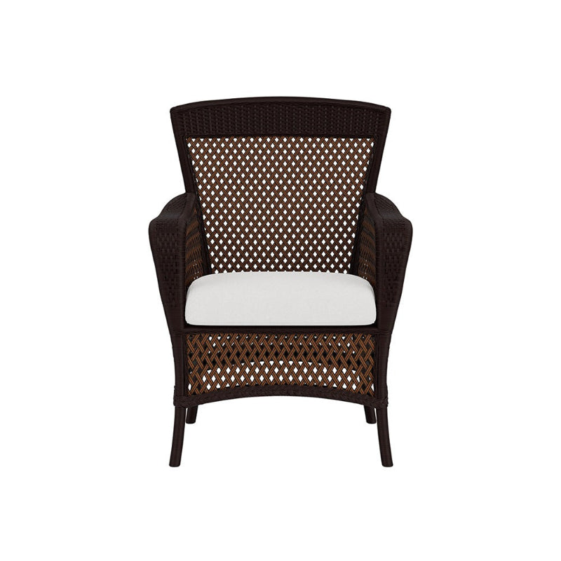 Wicker chair with a white cushion on a white background