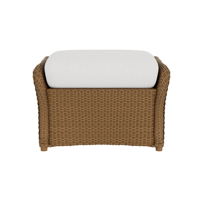 Wicker ottoman with a white cushion on a white background