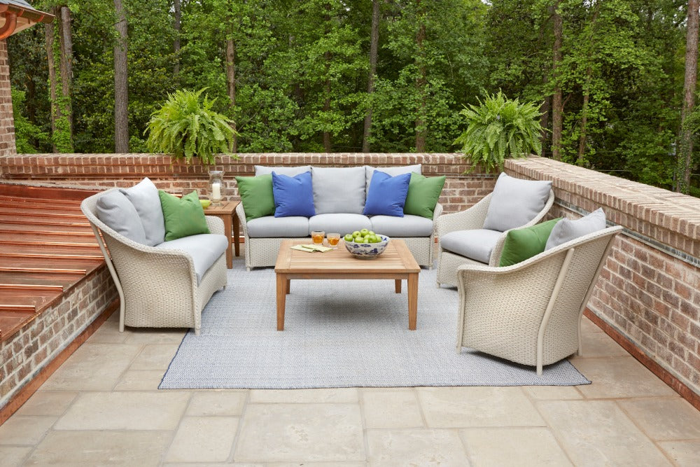 Outdoor patio with furniture and plants on a brick deck
