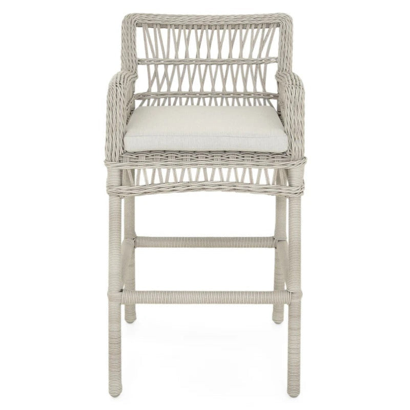 Wicker bar stool with a white cushion on a white background