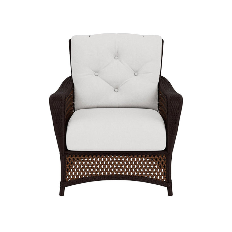 Wicker armchair with white cushion on a white background