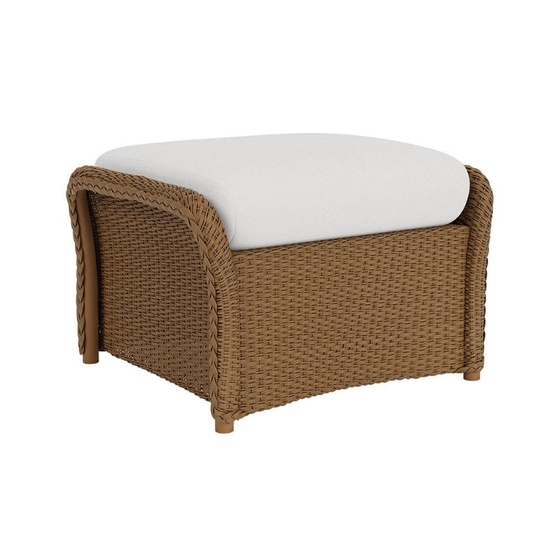Wicker ottoman with a white cushion on a white background
