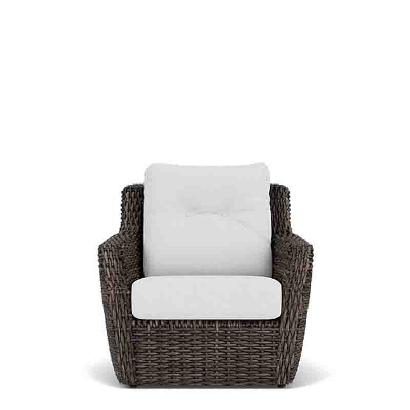 Wicker chair with white cushions on a white background