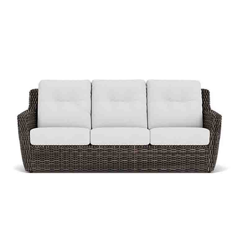 Wicker outdoor sofa with white cushions on a white background