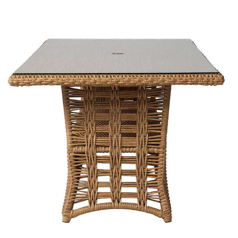 Wicker side table with glass top on a white background