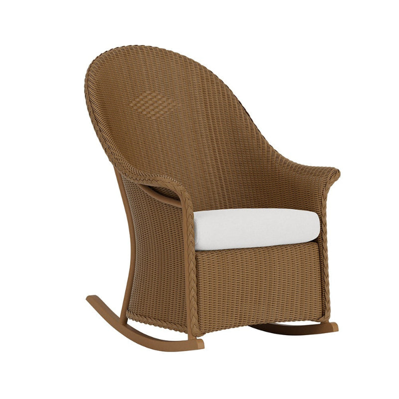 Brown wicker rocking chair with a white cushion on a white background