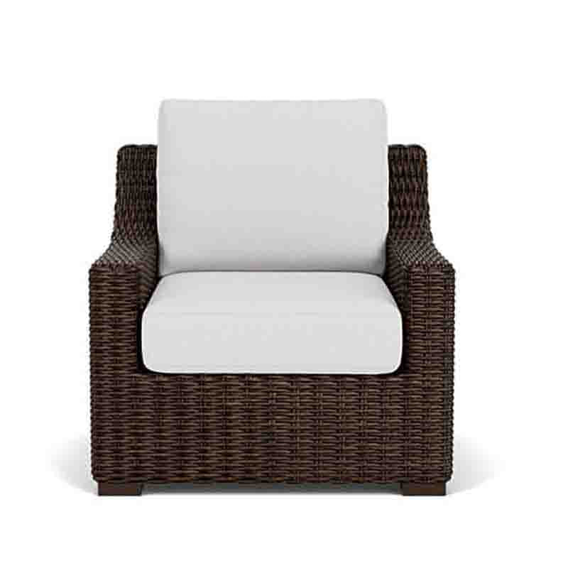Wicker armchair with white cushion on a white background