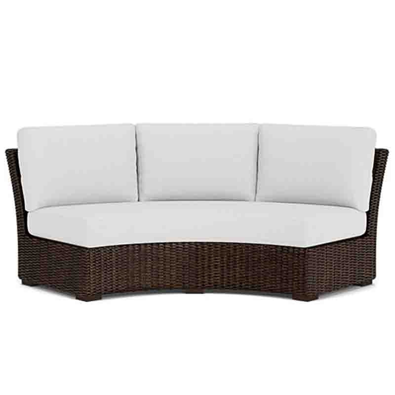 Wicker outdoor sofa with white cushions on a white background