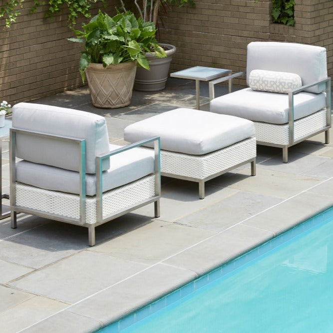 Outdoor patio furniture set with cushions by a pool
