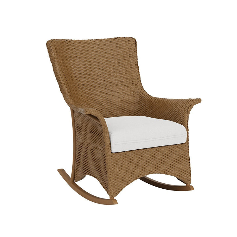Brown wicker rocking chair with a white cushion on a white background