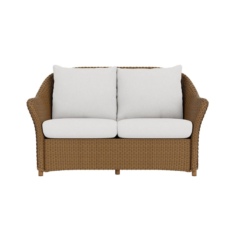 Brown wicker loveseat with white cushions on a white background