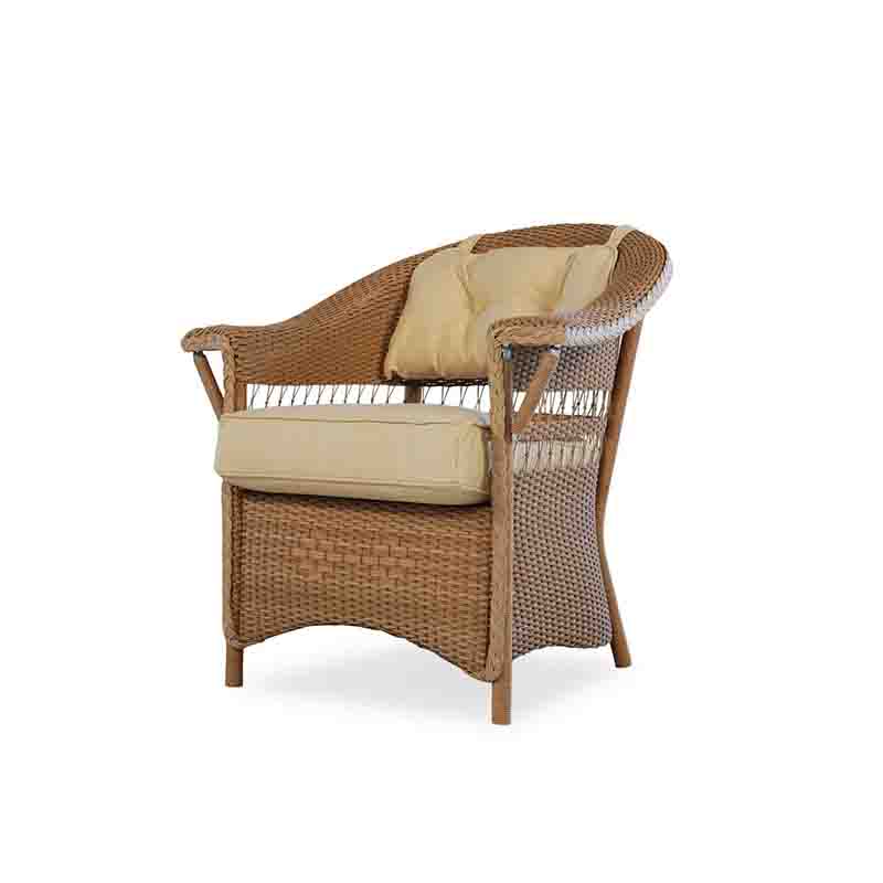 Wicker chair with beige cushions on a white background
