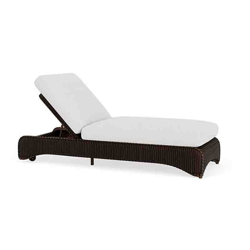 Brown wicker lounge chair with white cushion on a white background
