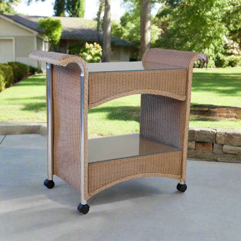 Wicker outdoor cart with glass top on a patio