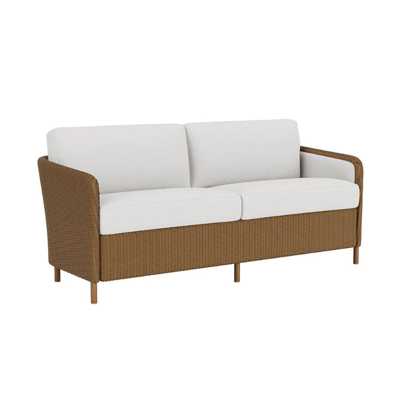 Brown wicker outdoor sofa with white cushions on a white background