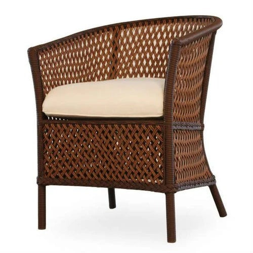 Wicker chair with a beige cushion on a white background
