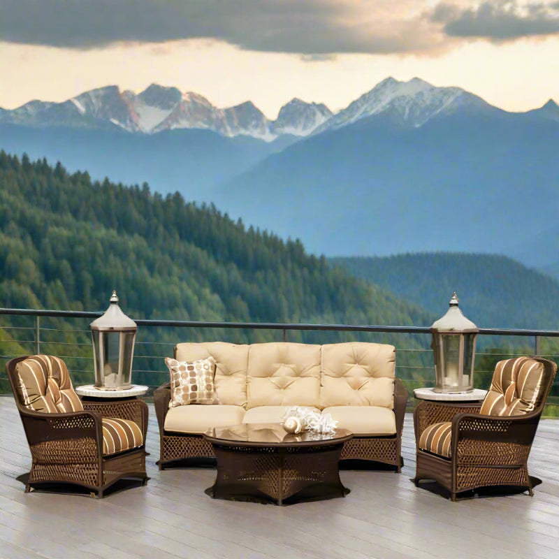 Outdoor patio set with beige cushions and striped armrests by a body of water.
