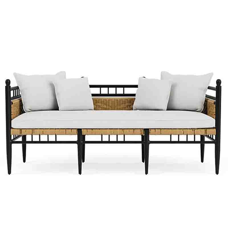 Wicker outdoor sofa with white cushions on a white background