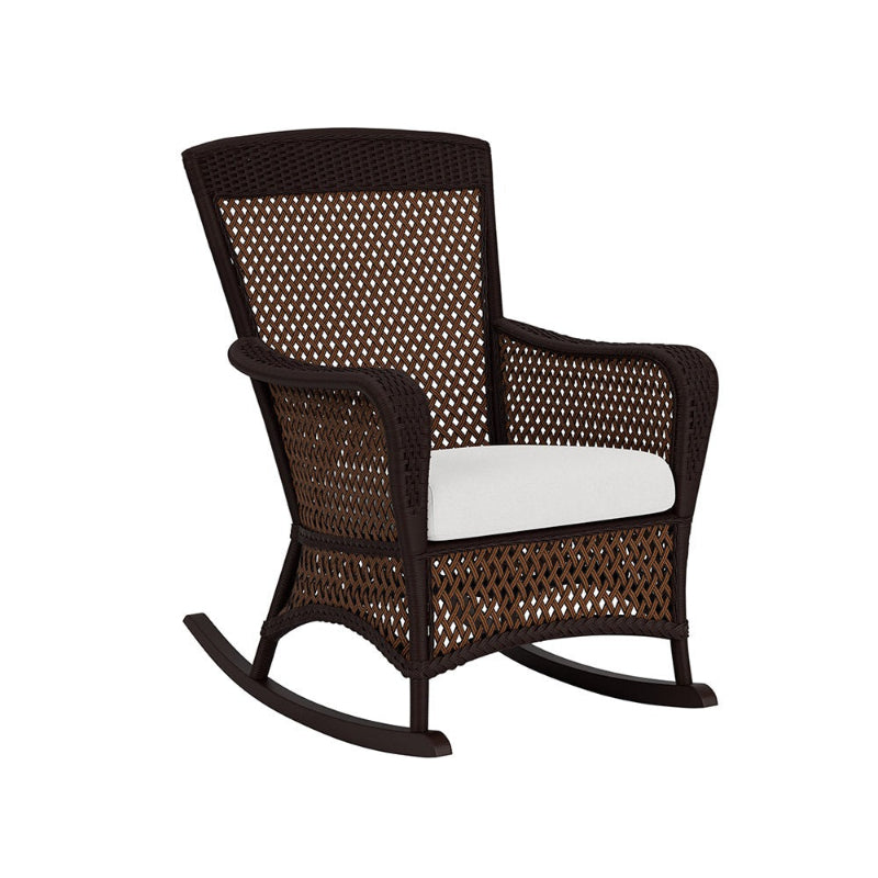 Wicker rocking chair with a white cushion on a white background