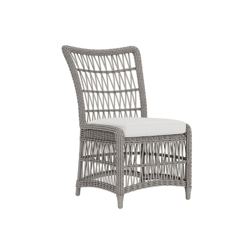 Wicker chair with a white cushion on a white background