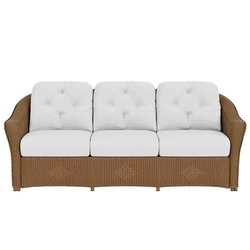 Brown wicker sofa with white cushions on a white background