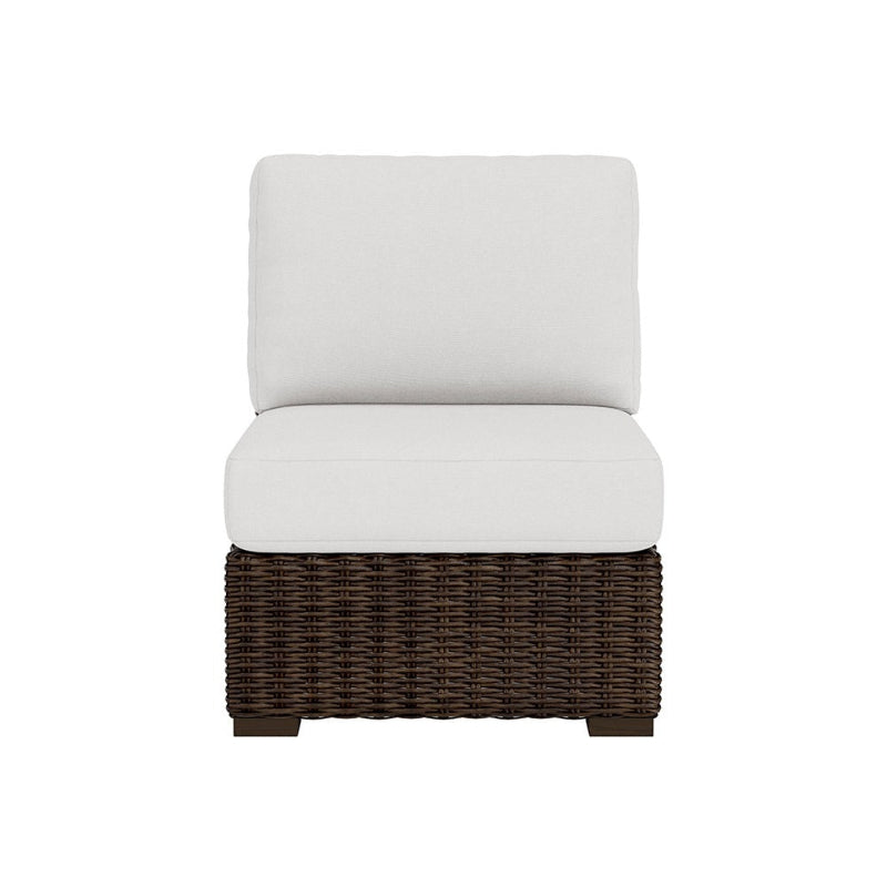 Wicker chair with white cushion on a white background