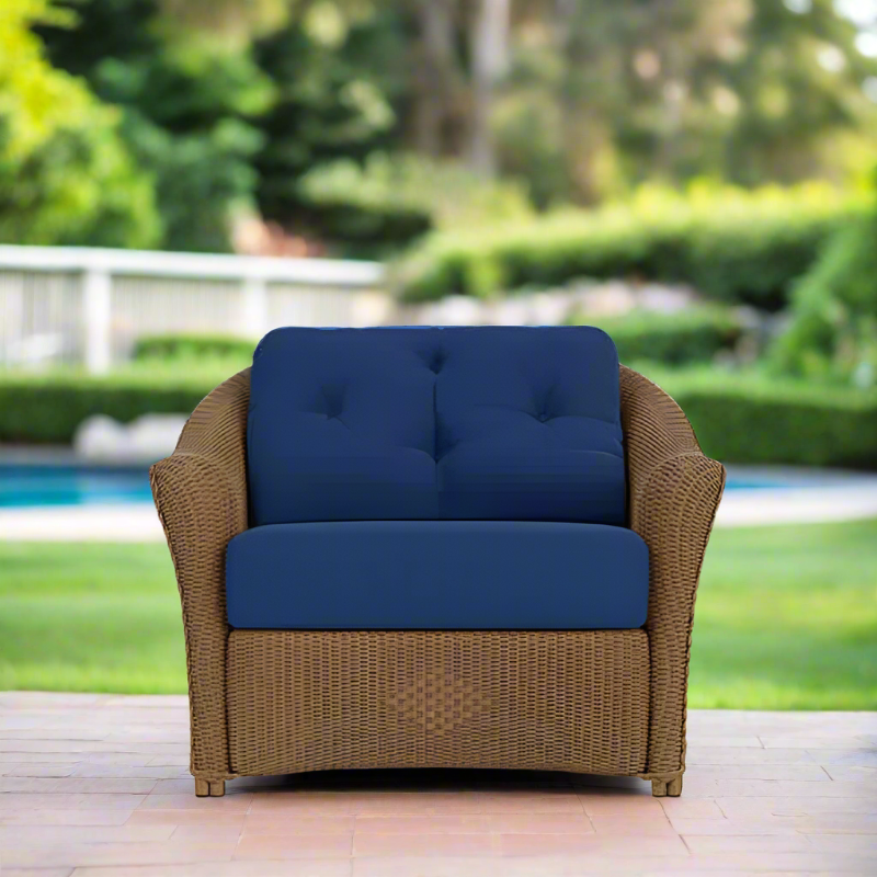 Wicker armchair with blue cushions in a garden setting