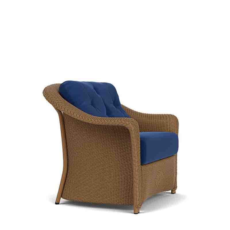 Wicker armchair with blue cushions on a white background