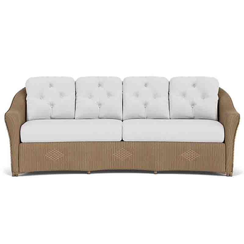 Sofa with white cushions and brown wicker frame on a white background