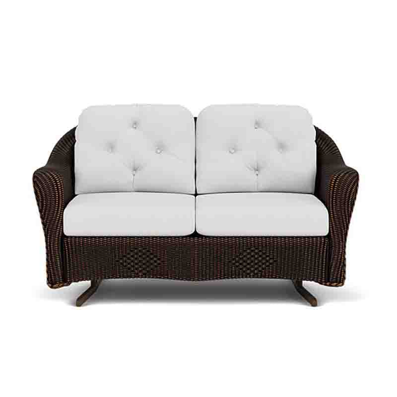 Wicker loveseat with white cushions on a white background