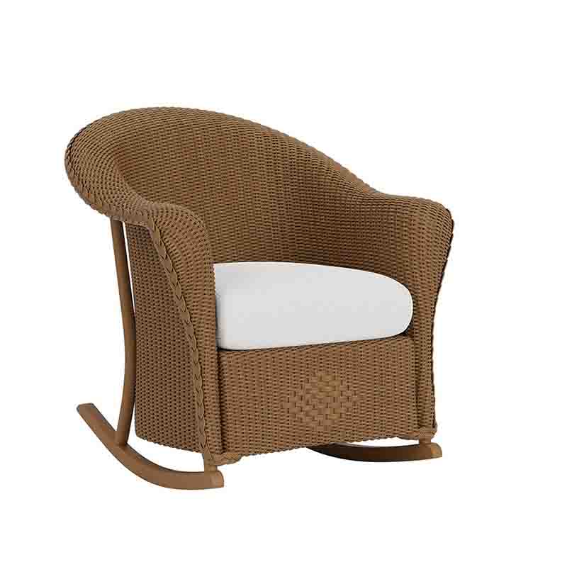 Brown wicker rocking chair with a white cushion on a white background
