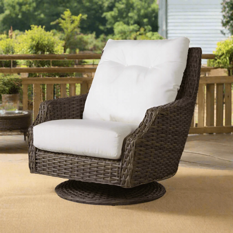 Wicker chair with white cushions on a patio