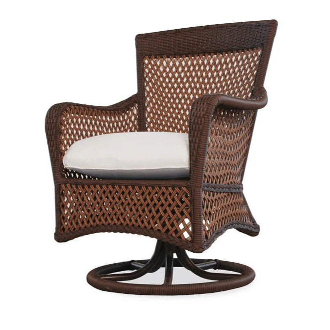 Brown wicker swivel chair with a white cushion on a white background