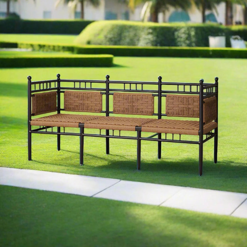 Outdoor patio bench with wicker seats and metal frame on a grassy area