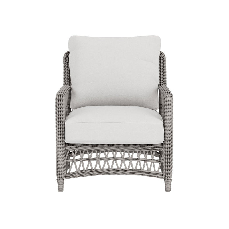 Wicker chair with white cushions on a white background