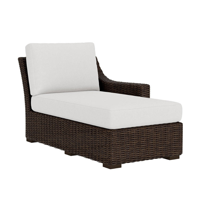 Brown wicker chair with white cushions on a white background
