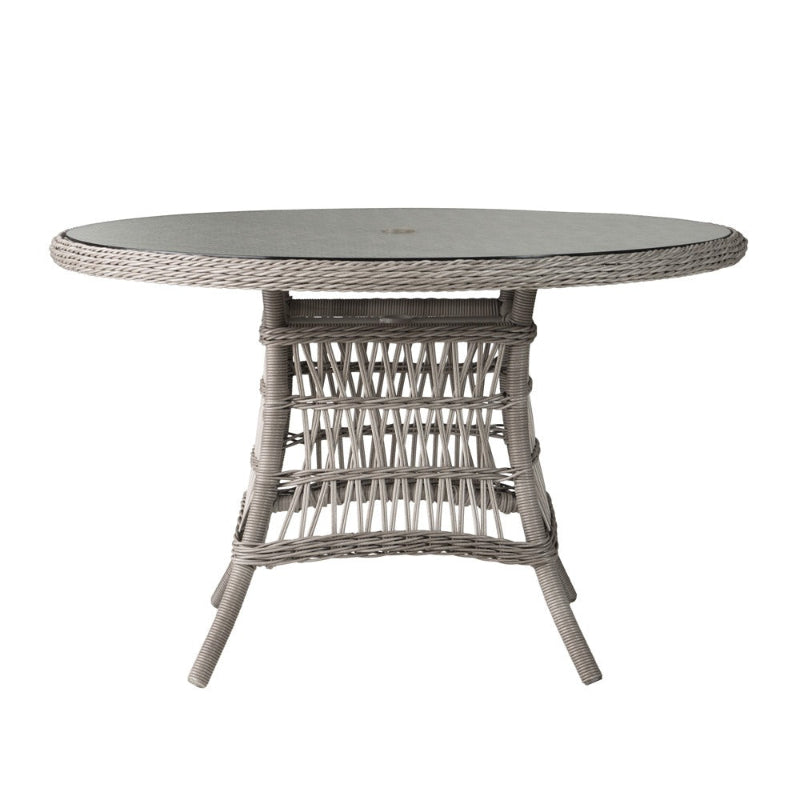 Round wicker table with glass top on a white background